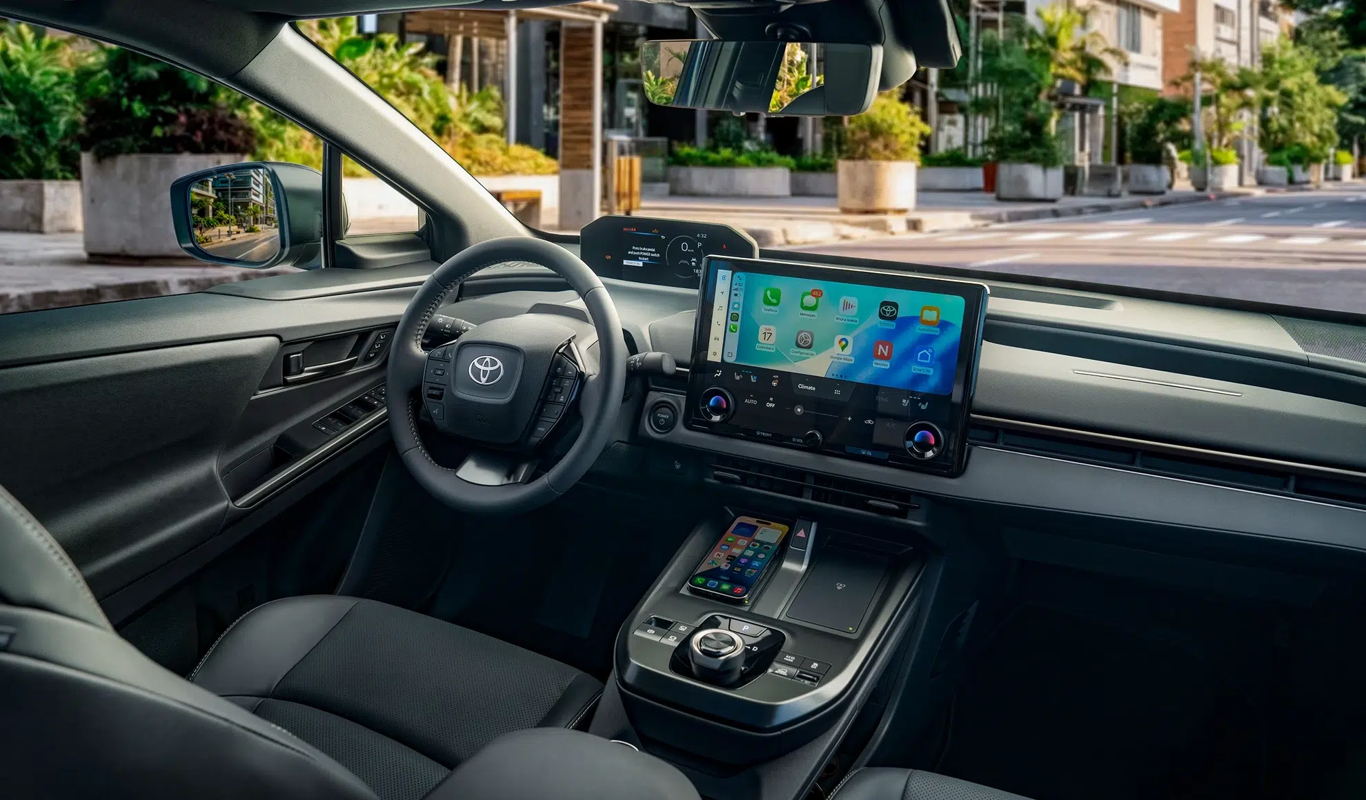 Interior of a modern car cockpit with a large tablet-style infotainment screen, steering wheel, and center console visible from the passenger seat.
