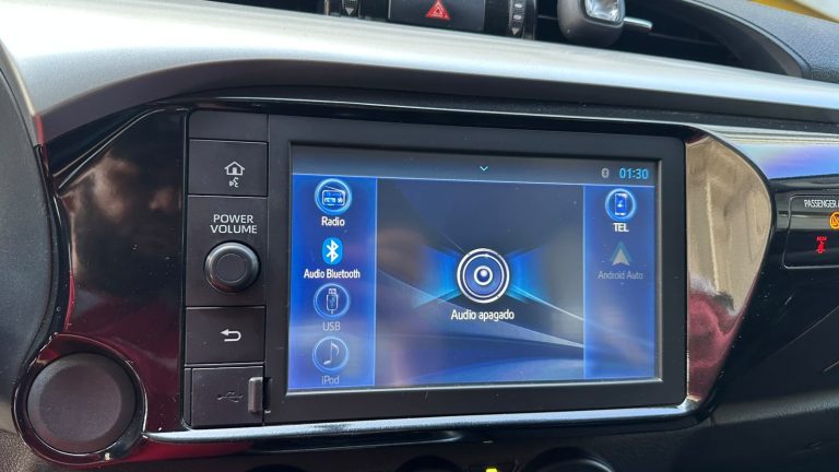 Car infotainment system with a blue home screen showing 'Audio off' in the center, left column icons for Radio, Bluetooth, USB, iPod, and right side 'Tel' and Android Auto access.